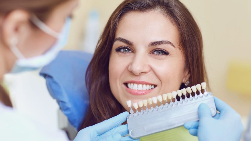 lady shade selecting with dentist Dental Crown and Bridges in Chandigarh