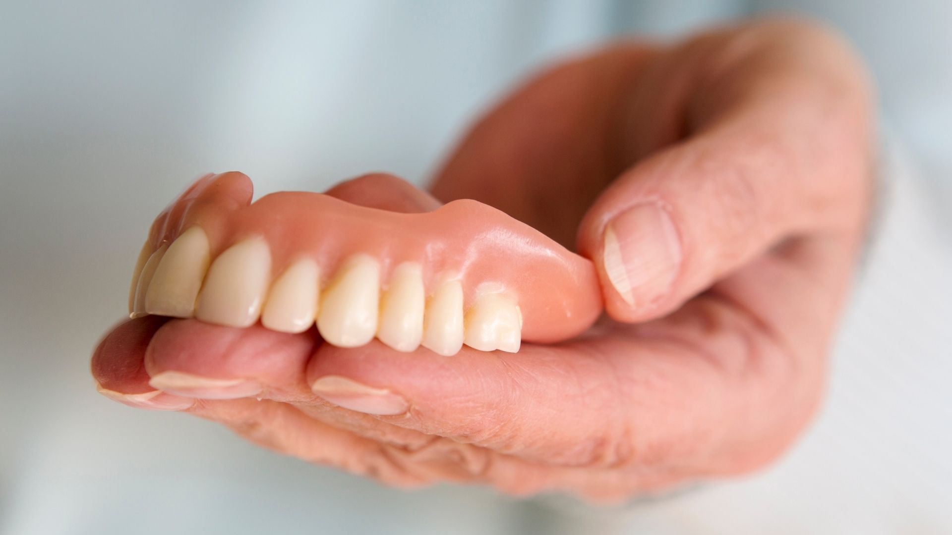 holding dentures in chandigarh in hands