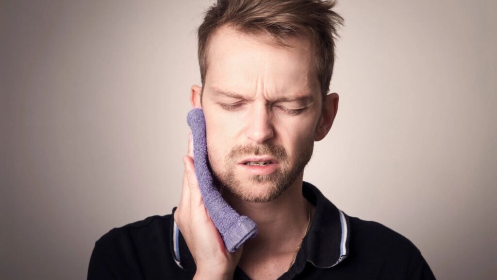 main in pain suffering from dental decay and cavities - root canal treatment in chandigarh